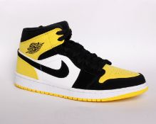 One pair of boxed as new Nike Air Jordan 1 MID SE in black/tour yellow/white (UK 9.5).