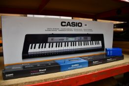 A boxed as Casio keyboard CTK-1550 with stand and AC adaptor.