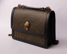 An as new Kurt Geiger gold coloured studded shoulder bag with bird head clasp.