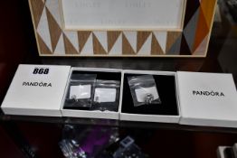 An as new Pandora garden scene Murano glass charm and two Pandora pendent charms to include entwined