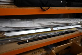 A shelf of miscellaneous items to include plastic tubing and metal support brackets.