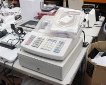 A Sharp XE-A203 electronic cash register with key and instruction manual.