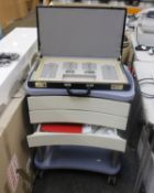 A adjustable optical trial lens set with trolley and stool.