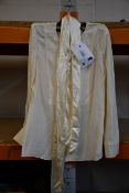 An as new Tory Burch silk cream tie blouse (Size 4).