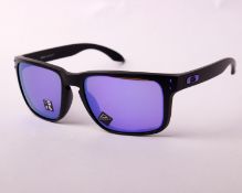 A pair of boxed as new Oakley sunglasses.