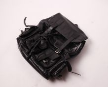 A pre-owned black leather Saint Laurent back pack with multi pouches to body.