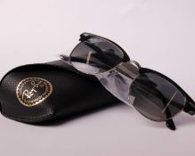 A pair of boxed as new Ray Ban sunglasses.