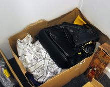 A box of pre-owned handbags and related items.