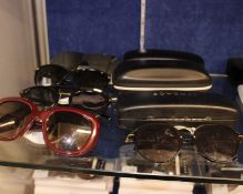 Eight pairs of pre-owned branded sunglasses.