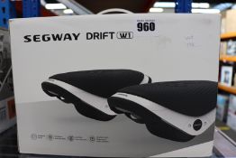 One pair of boxed as new Segway Drift W1 E-Skates in black and white.