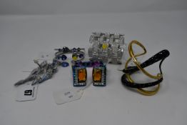 Four assorted as new Swarovski cuffs and a pair of clip-on earrings (Unboxed, No Tags).
