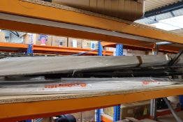 A shelf of miscellaneous items to include plastic tubing and metal support brackets.