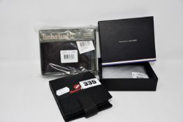 Three assorted as new wallets to include Timberland, Tommy Hilfiger and Roam Lite.