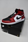 A pair of as new Nike Air Jordan 1 Mid sneakers (UK 8).