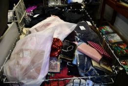 A large basket of assorted clothing and related items to include trouser, t-shirts, jumper.