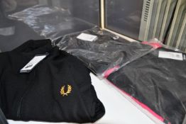 Three items of as new Fred Perry clothing; a long sleeve taped dress (Size 10), taped sleeve track