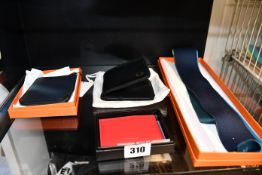 An as new Hermes tie, a pre-owned Hermes purse (Excellent condition with box), an as new Fred