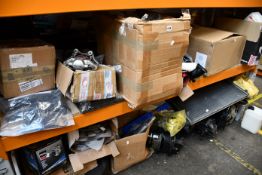 Two shelves of car parts and related items to include one motorbike exhaust, one Remy alternator and