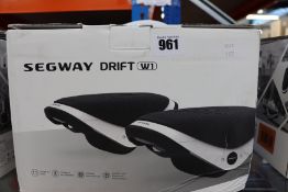 One pair of boxed as new Segway Drift W1 E-Skates in black and white.