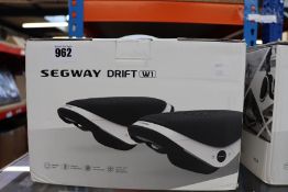 One pair of boxed as new Segway Drift W1 E-Skates in black and white.