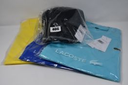 Three as new Lacoste t-shirts (US XS, L, XL) and a Lacoste baseball cap.