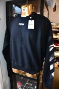 An as new Off White Caravaggio Arrow crew neck sweater in black (XS).