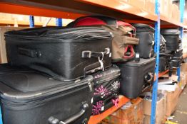 Thirteen suitcases containing clothing and related items.