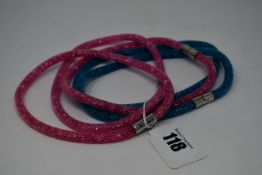Three as new Swarovski pink Stardust (M) wrap round bracelets and two blue Swarovski wrap round