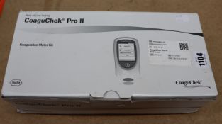 One boxed as new CoaguCheck Pro II coagulation meter kit.