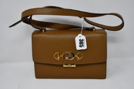 An as new Gucci handbag in brown leather.