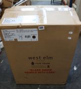 A boxed as new West Elm Jensen round side table with dark walnut veneer legs and glass top.