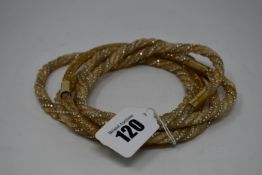 Four as new Swarovski gold coloured twist necklaces (M) and one Swarovski Stardust gold coloured