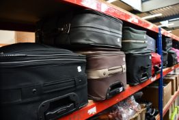 Twelve suitcases containing clothing and related items.