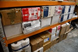 A large quantity of paper hand towels and related items.