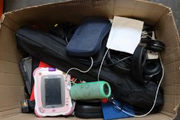 A box of assorted headphones, cases and small electrical items.
