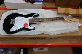 One boxed as new Fender Squier Mini Strat in black and white.
