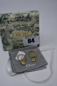A pair of as new Dior star and locket earrings with pouch and box.