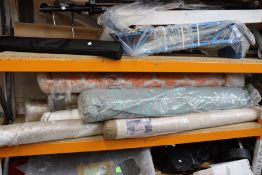 A shelf of carpets/rugs and related items.