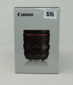 A boxed as new Canon EF 24-70 mm f/4L IS USM lens with lens case and lens hood.