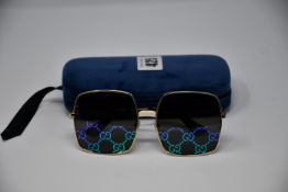 A pair of as new Gucci sunglasses.