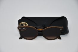 A pair of as new Ray Ban sunglasses.