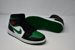 A pair of as new Nike Air Jordan Mid sneakers (UK 9).