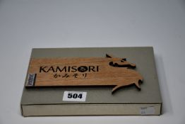 One boxed as new Kamisori precious metal hairdressing scissors.