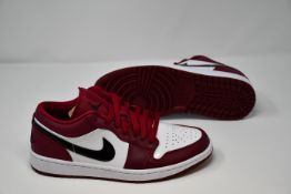 A pair of as new Nike Air Jordan 1 Low sneakers (UK 7.5) (Slight marks to one of the trainers on