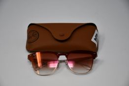 A pair of as new Ray Ban sunglasses.