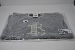 An as new Ralph Lauren 3/4 sleeve grey/cream sweater with with motif to front (Size M).