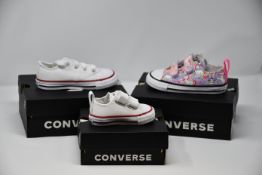 Seven assorted pairs of toddler/junior Converse footwear.