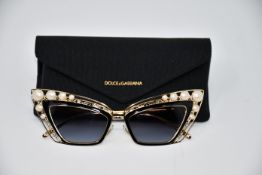 A pair of as new Dolce & Gabbana sunglasses (Scratch on top of cardboard box but glasses and case