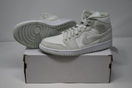 A pair of women's as new Nike Air Jordan 1 Mid sneakers (UK 7).