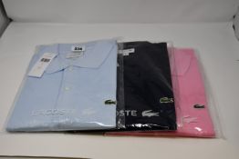 Three as new Lacoste polo shirts (2 x FR 4, 1 x FR 7).